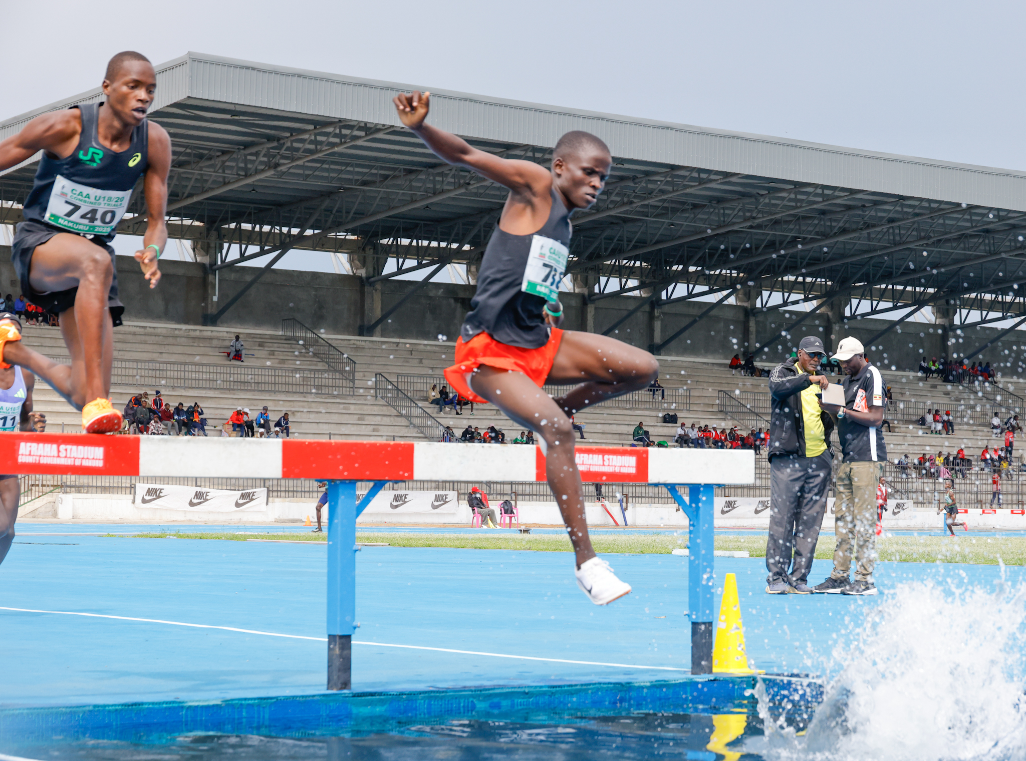 Brian Kiptoo (R) clears the water jump barrier in the men's 2000m Sc u18 race at Africa U18/20 trials in Nakuru