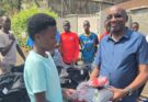 Barnaba Korir presents Team Kenya kits to U20 athletes.